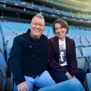 Image of Jimmy Barnes and Virginia Trioli sitting on blue seats at a stadium together.