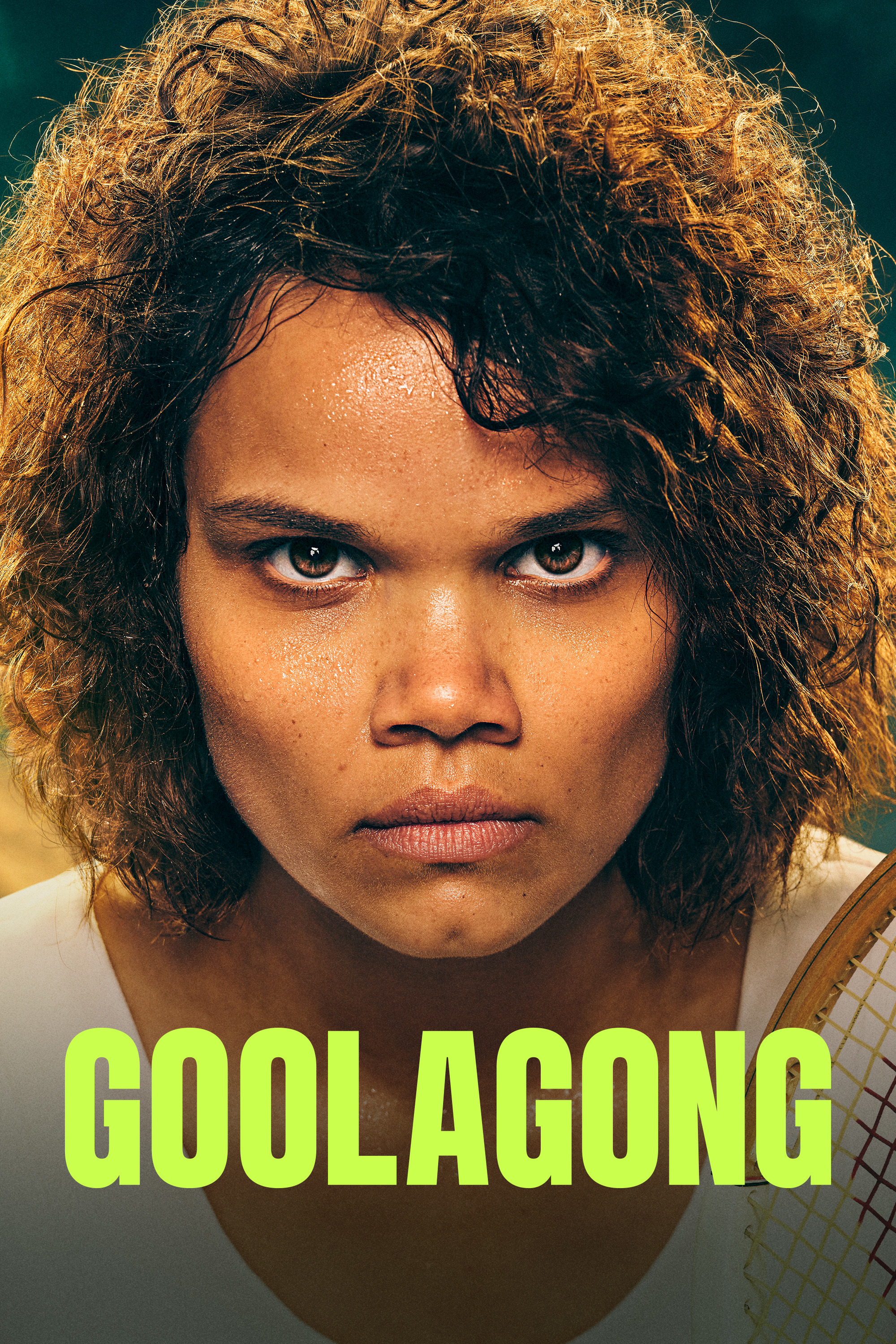 Close-up intense portrait of a woman with curly hair holding a tennis racket for the title GOOLAGONG.